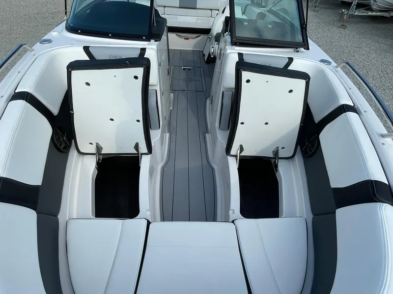 Slide: The Image of 2025 Chaparral 270 OSX boat interior with open storage compartments and sleek seating. - 16