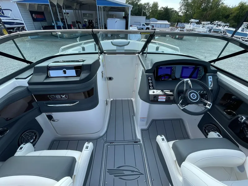 Slide: The Image of 2025 Chaparral 270 OSX boat cockpit with modern controls and seating. - 18