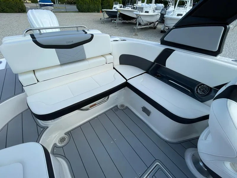 Slide: The Image of 2025 Chaparral 270 OSX boat interior with sleek white seating and modern design. - 29