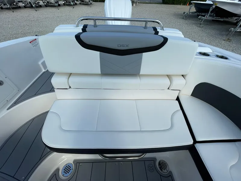 Slide: The Image of 2025 Chaparral 270 OSX boat interior with white cushioned seating. - 39