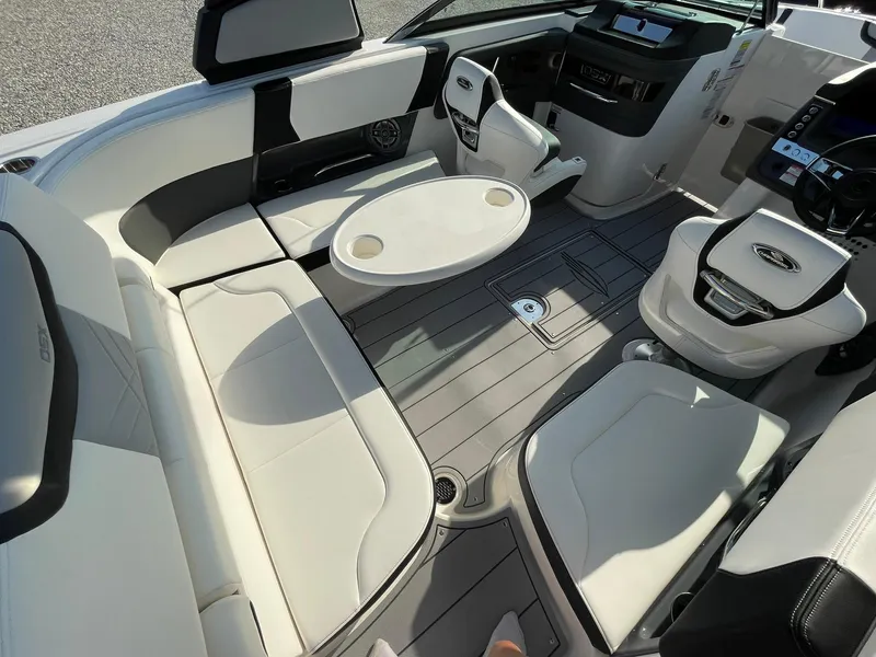 Slide: The Image of 2025 Chaparral 270 OSX boat interior with sleek seating and modern dashboard. - 49