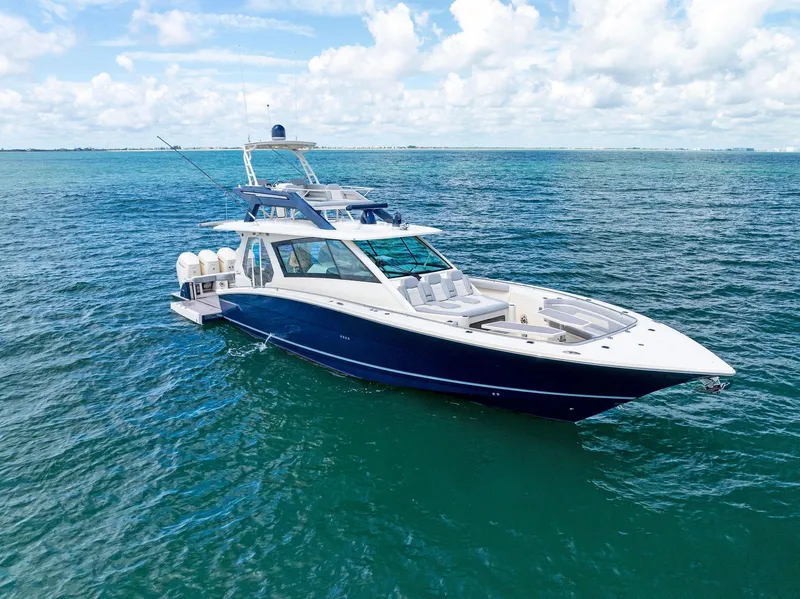 Slide: The Image of 2022 Scout LXF boat cruising on clear blue ocean waters. - 14