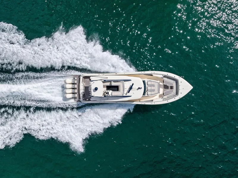 Slide: The Image of Aerial view of 2022 Scout LXF boat cruising on turquoise water. - 2