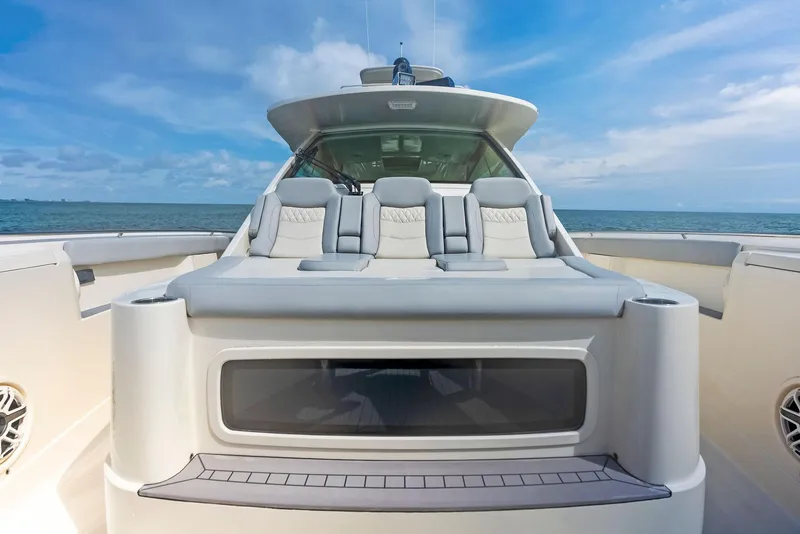 Slide: The Image of 2022 Scout LXF luxury boat with spacious seating and ocean backdrop. - 21