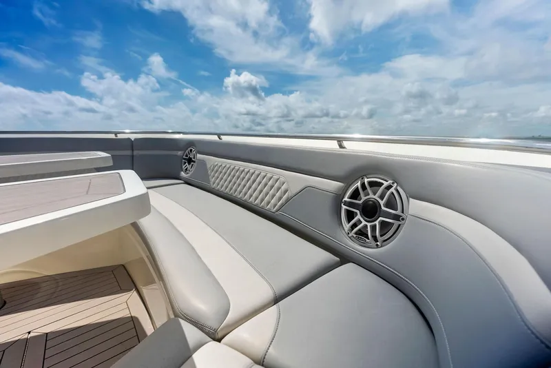 Slide: The Image of 2022 Scout LXF boat interior with luxurious seating and speakers under a blue sky. - 25