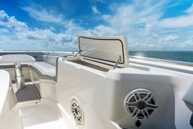 Slide: The Image of 2022 Scout LXF boat interior with open storage, speakers, and ocean view. - 28
