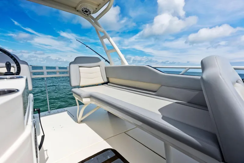 Slide: The Image of 2022 Scout LXF boat interior with cushioned seating, ocean view, and blue sky. - 31