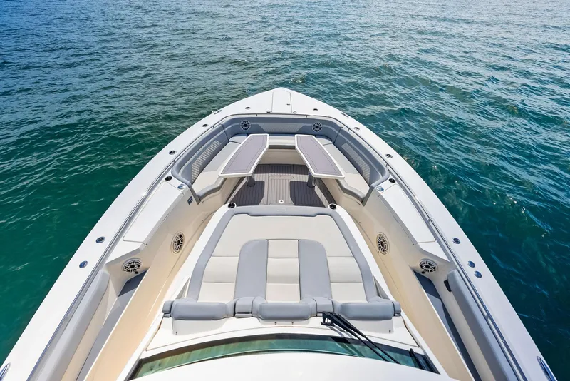 Slide: The Image of 2022 Scout LXF boat bow with seating, on calm blue water. - 34