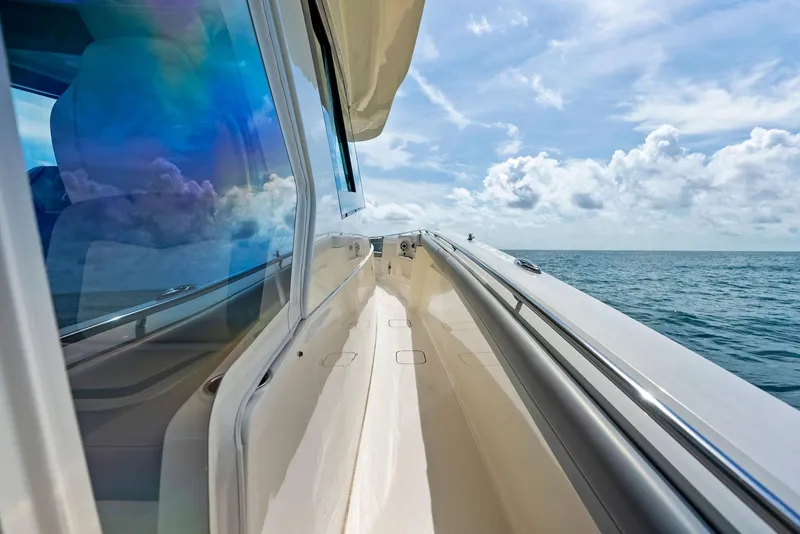 Slide: The Image of 2022 Scout LXF boat cruising on open sea under blue sky. - 35