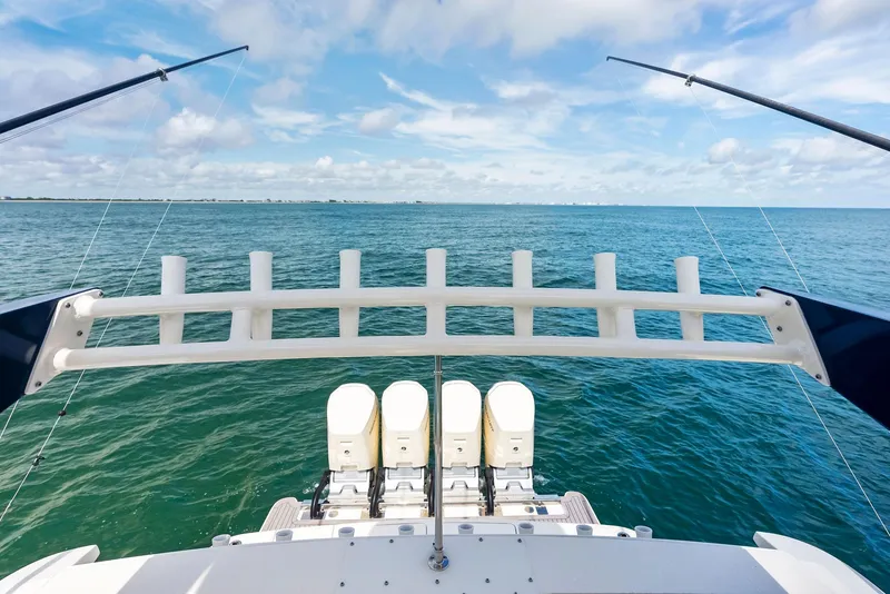 Slide: The Image of 2022 Scout LXF boat with fishing rods and ocean view. - 38