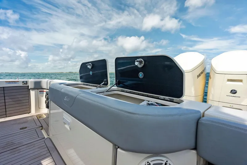 Slide: The Image of 2022 Scout LXF boat deck with dual outboard motors under a blue sky. - 39