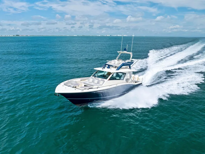 Slide: The Image of 2022 Scout LXF boat cruising on open blue ocean under clear skies. - 4