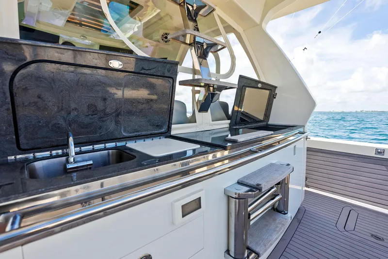 Slide: The Image of 2022 Scout LXF boat with sleek outdoor kitchen and ocean view. - 41