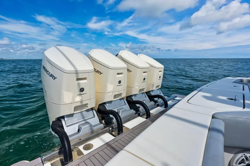 Slide: The Image of 2022 Scout LXF boat with four Mercury outboard engines on open water. - 47