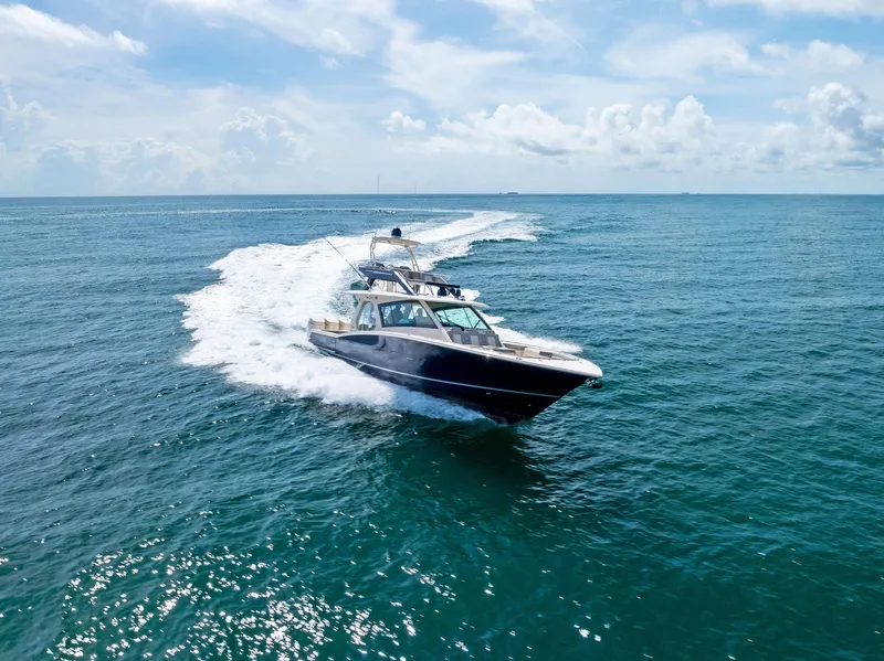 Slide: The Image of 2022 Scout LXF boat cruising on open ocean under clear skies. - 7