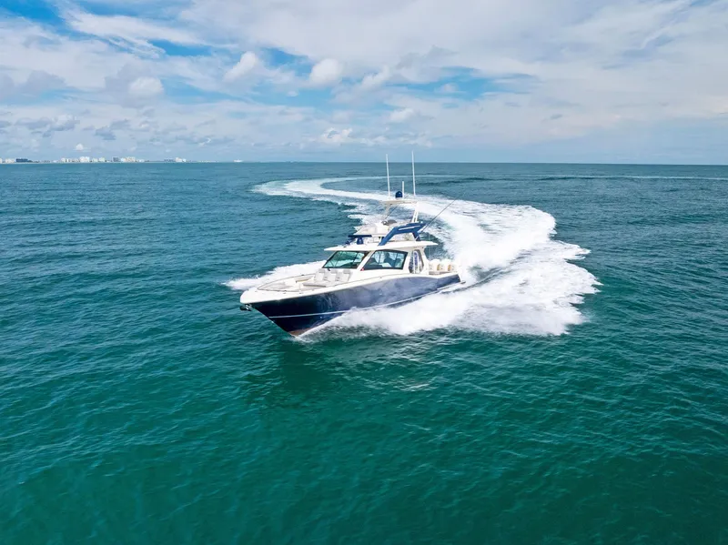 Slide: The Image of 2022 Scout LXF boat cruising on open ocean under clear blue sky. - 9