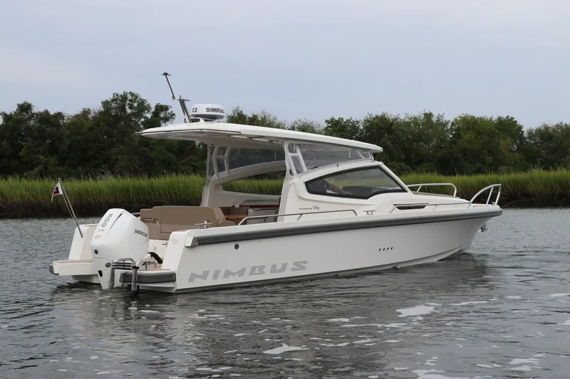 Slide: The Image of 2024 Nimbus Weekender 9 boat on calm water, side view. - 10