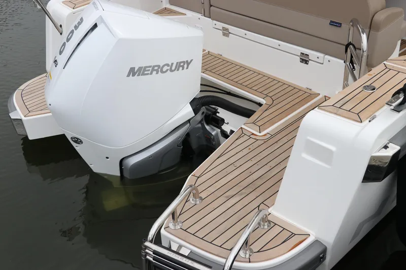 Slide: The Image of 2024 Nimbus Weekender 9 boat with Mercury outboard engine and teak deck. - 12