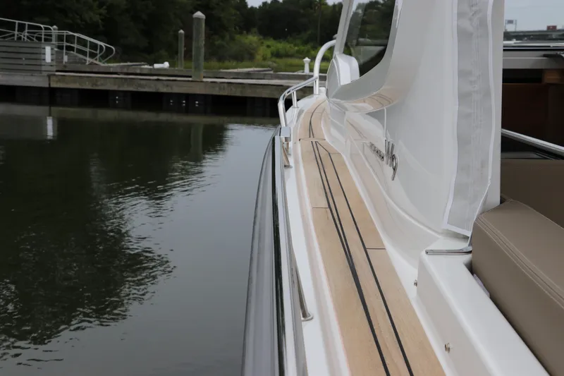 Slide: The Image of 2024 Nimbus Weekender 9 boat docked by calm waters. - 18