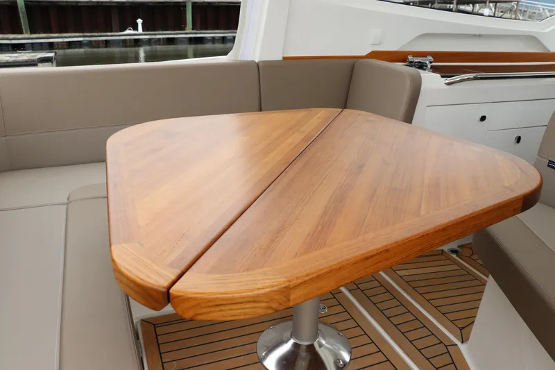 Slide: The Image of 2024 Nimbus Weekender 9 interior with wooden table and cushioned seating. - 25