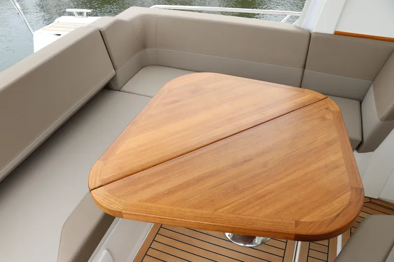 Slide: The Image of Luxurious seating area on 2024 Nimbus Weekender 9 with wooden table. - 26