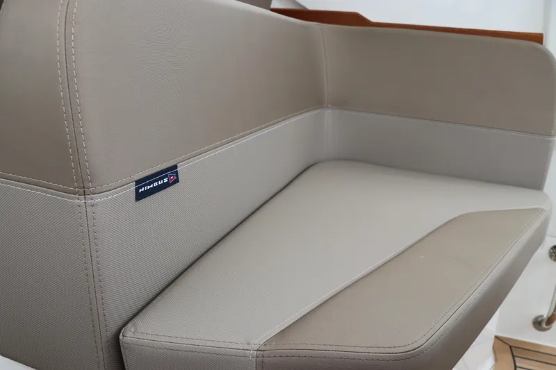 Slide: The Image of 2024 Nimbus Weekender 9 boat seat with beige upholstery and sleek design. - 28