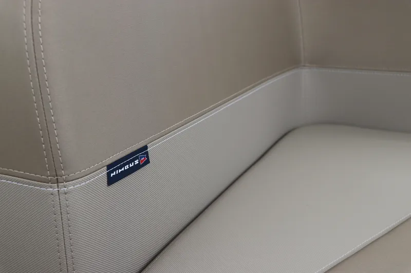 Slide: The Image of 2024 Nimbus Weekender 9 beige interior seating detail with logo. - 29