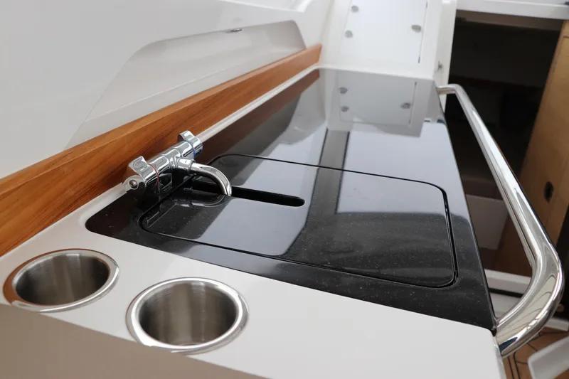 Slide: The Image of 2024 Nimbus Weekender 9 boat interior with sleek kitchen counter and stainless steel fixtures. - 32