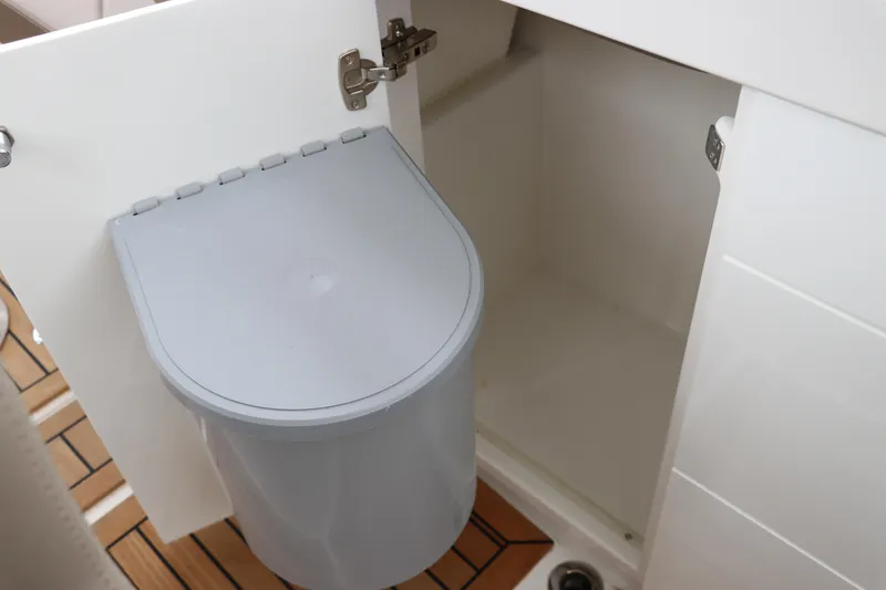 Slide: The Image of 2024 Nimbus Weekender 9 interior with open cabinet and trash bin. - 34