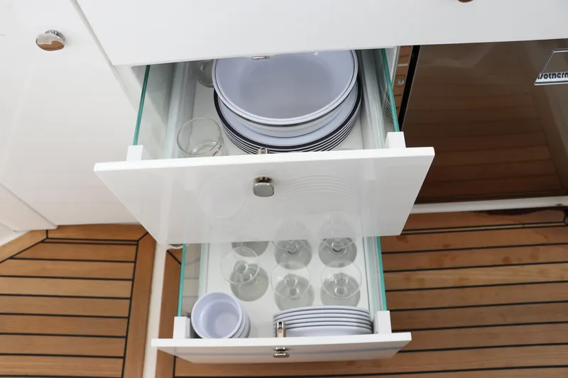 Slide: The Image of Nimbus Weekender 9 (2024) kitchen drawers with neatly organized dishes and glasses. - 35