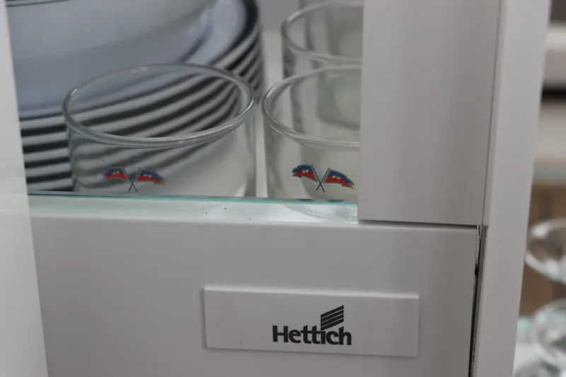 Slide: The Image of Glassware and plates in a Hettich cabinet, Nimbus Weekender 9, 2024 model. - 38