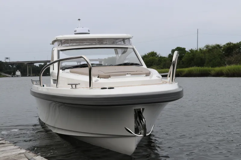 Slide: The Image of 2024 Nimbus Weekender 9 boat docked on calm water. - 4