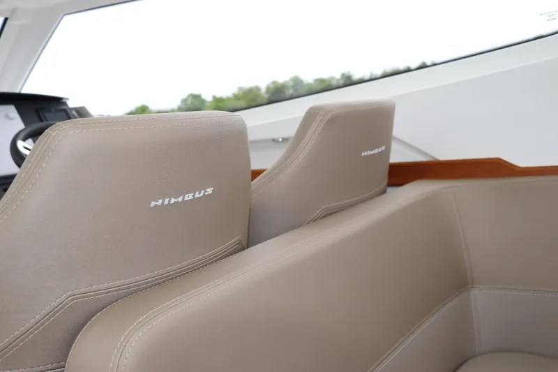 Slide: The Image of 2024 Nimbus Weekender 9 boat interior with beige leather seats. - 42