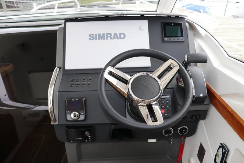 Slide: The Image of 2024 Nimbus Weekender 9 helm with Simrad navigation system and modern steering wheel. - 49