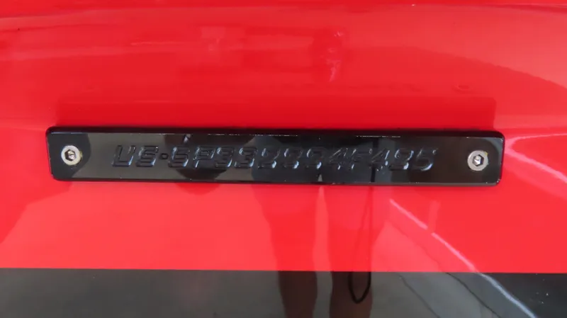 Slide: The Image of 2025 Sunsation 32 CCX boat nameplate on a vibrant red surface. - 23