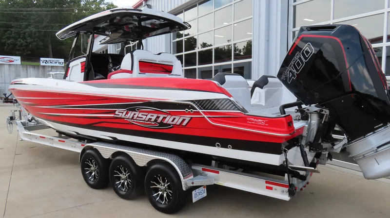 Slide: The Image of 2025 Sunsation 32 CCX boat with vibrant red design on a trailer. - 6