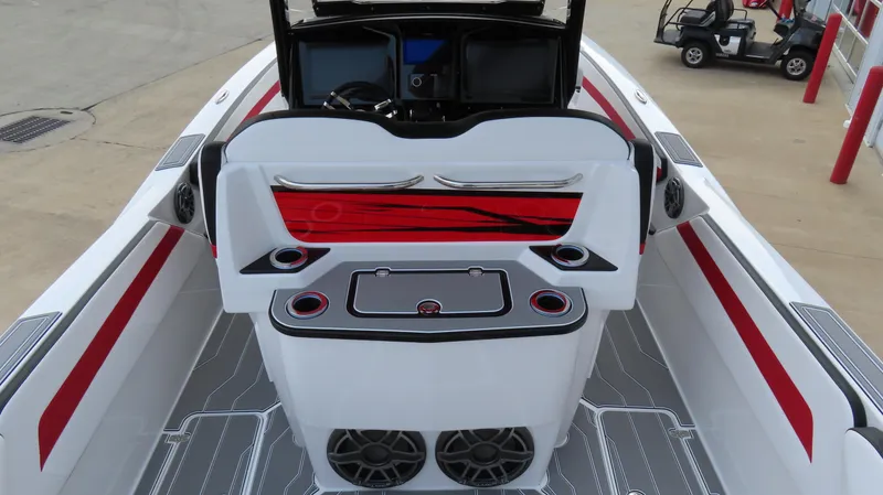 Slide: The Image of 2025 Sunsation 32 CCX boat interior with red accents and modern dashboard. - 8