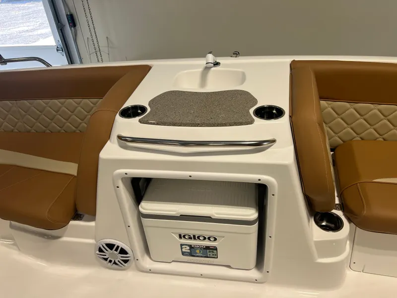 Slide: The Image of 2025 NauticStar 203 SC Deck boat interior with seating, sink, and Igloo cooler. - 10