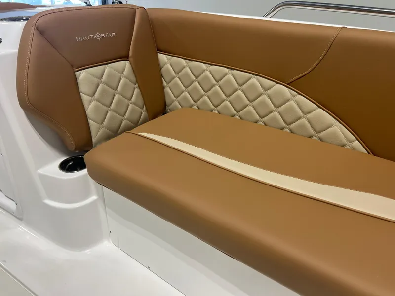 Slide: The Image of 2025 NauticStar 203 SC Deck boat seat with tan and cream quilted upholstery. - 3