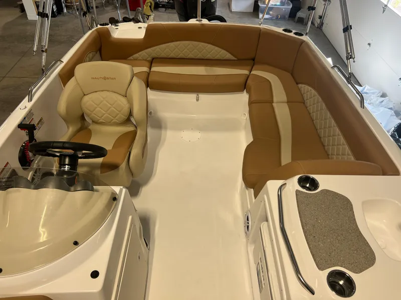 Slide: The Image of 2025 NauticStar 203 SC Deck boat interior with tan seating and steering console. - 4