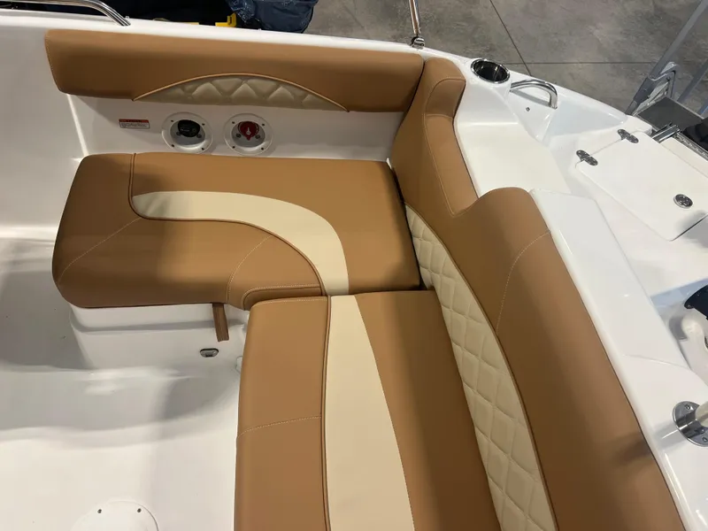 Slide: The Image of 2025 NauticStar 203 SC Deck boat with tan and cream cushioned seating. - 7