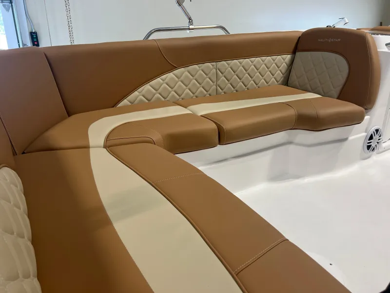 Slide: The Image of Luxurious seating on 2025 NauticStar 203 SC Deck boat with tan and cream upholstery. - 9