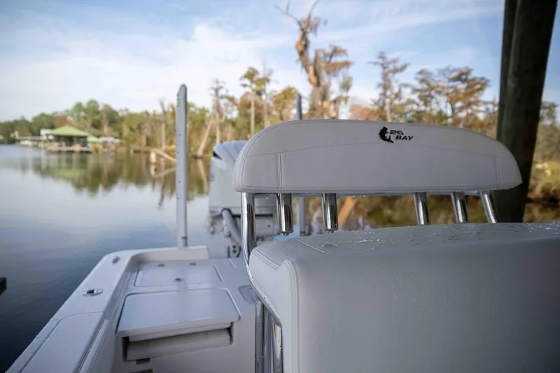 Slide: The Image of 2024 Contender 26 Bay boat on calm lake with scenic background. - 10
