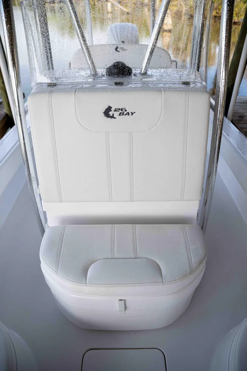 Slide: The Image of 2024 Contender 26 Bay boat with white cushioned seating and sleek design. - 18