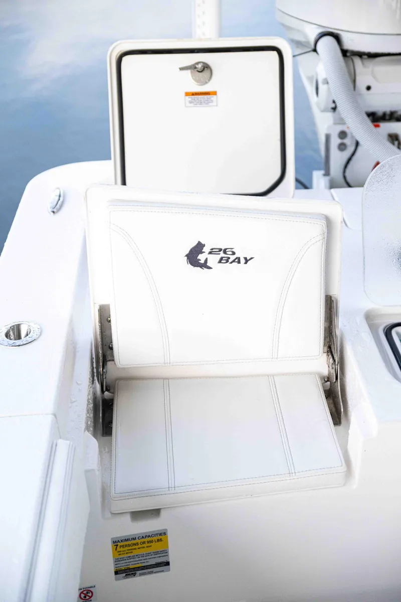 Slide: The Image of 2024 Contender 26 Bay boat seat with logo, white upholstery. - 20