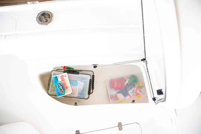Slide: The Image of Storage compartment in 2024 Contender 26 Bay boat with fishing gear. - 24