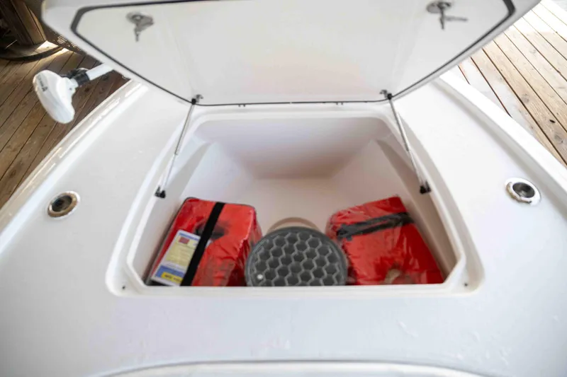 Slide: The Image of 2024 Contender 26 Bay boat storage compartment with safety gear and equipment. - 26