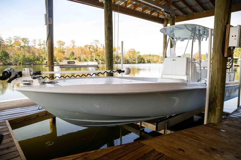 Slide: The Image of 2024 Contender 26 Bay boat docked in a serene lakeside setting. - 29