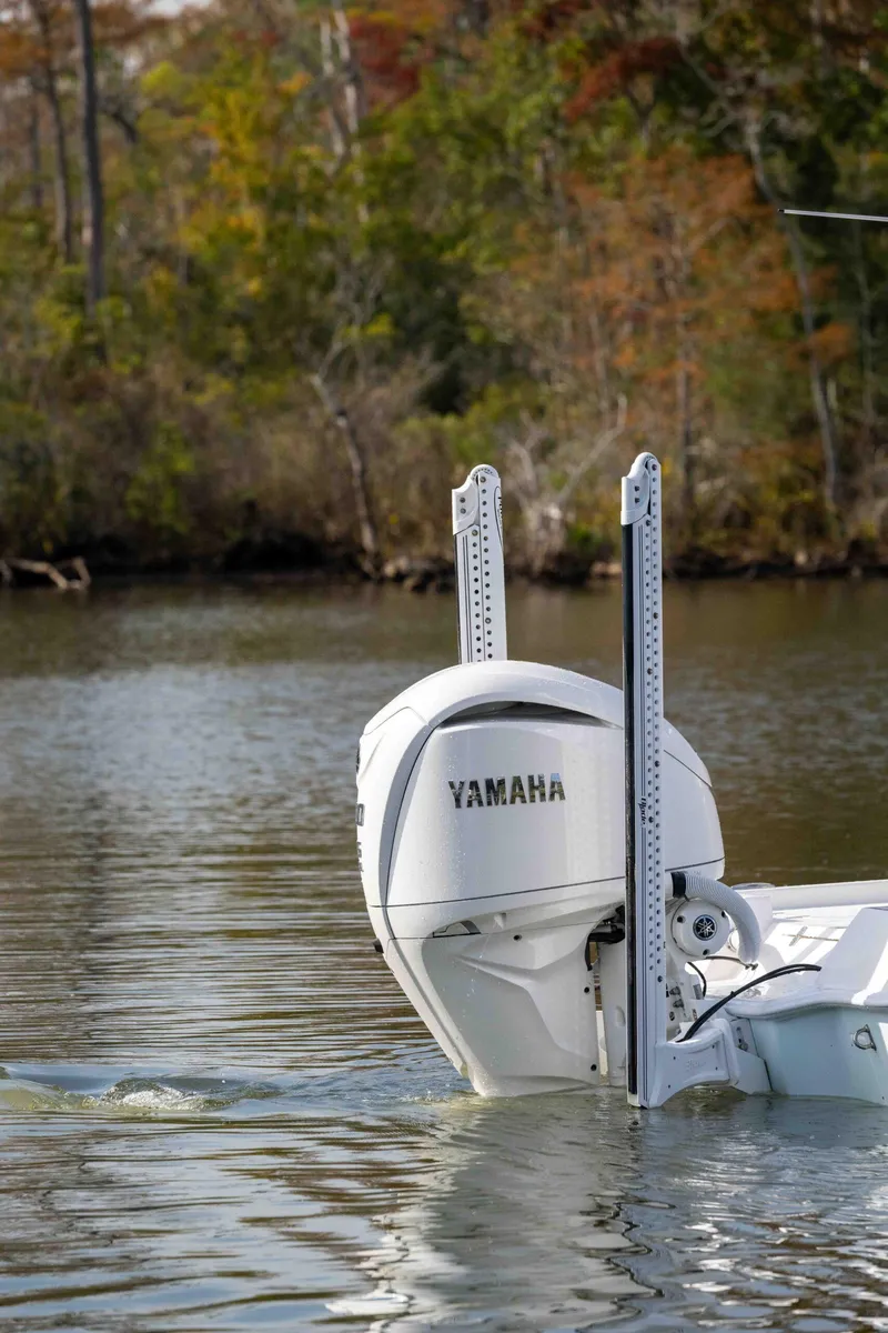 Slide: The Image of 2024 Contender 26 Bay boat with Yamaha engine on a calm lake. - 3
