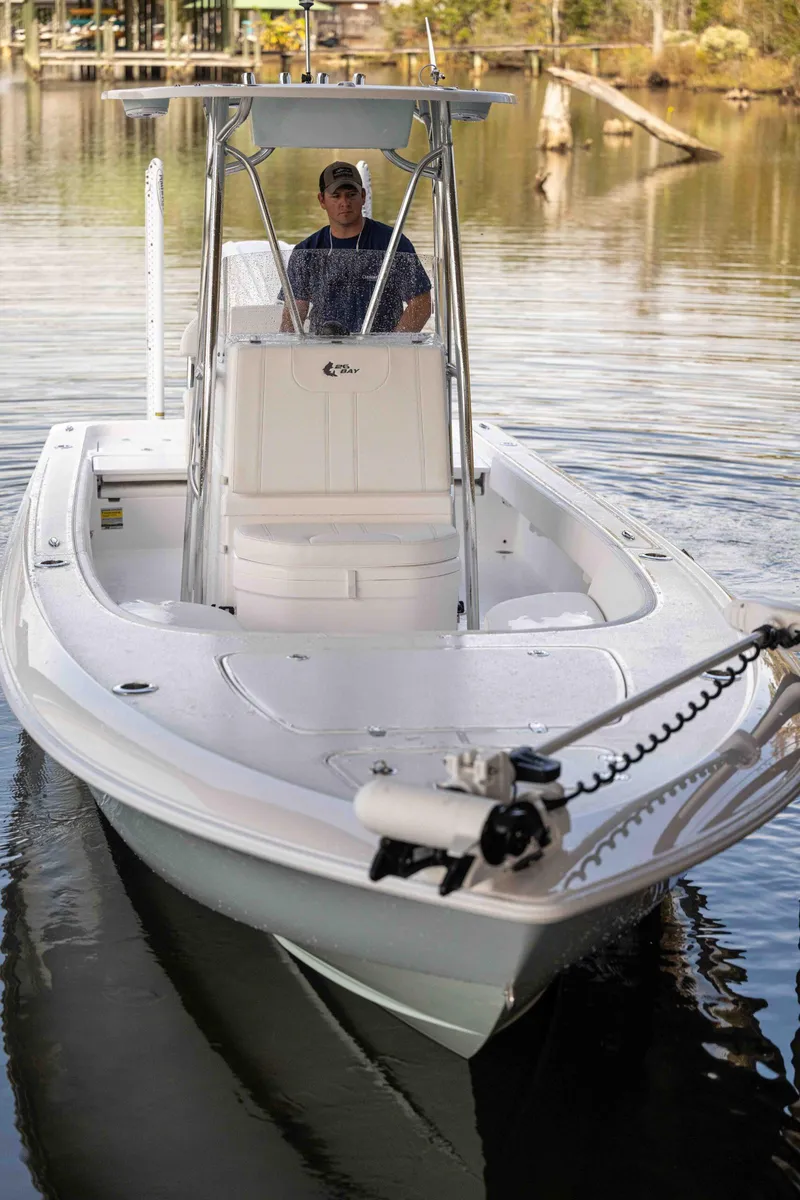 Slide: The Image of 2024 Contender 26 Bay boat on calm water, featuring sleek design and modern features. - 6